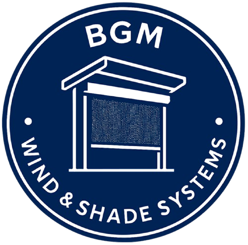 A circular blue and white logo with “BGM” at the top and “Wind & Shade Systems” at the bottom, featuring a stylized image of a shaded outdoor structure in the center.
